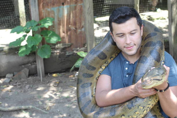 Man with a giant Anaconda around his neck