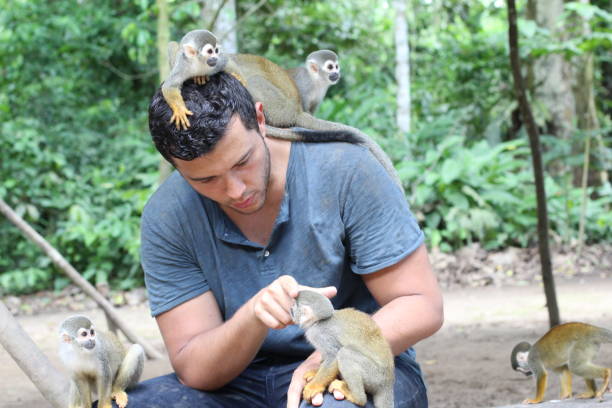 istock Handsome ethnic man with titi monkeys 1071079306