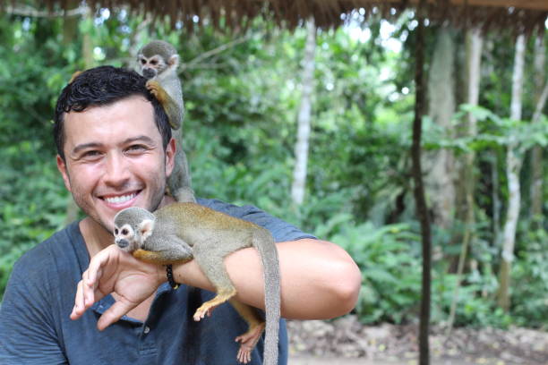 istock Handsome ethnic man with titi monkeys 1071079312
