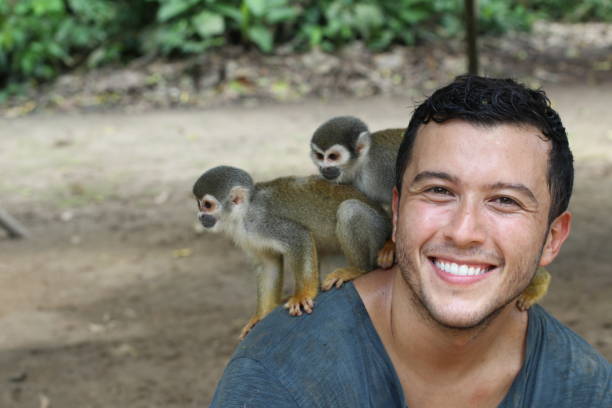 istock Handsome ethnic man with titi monkeys 1071079322
