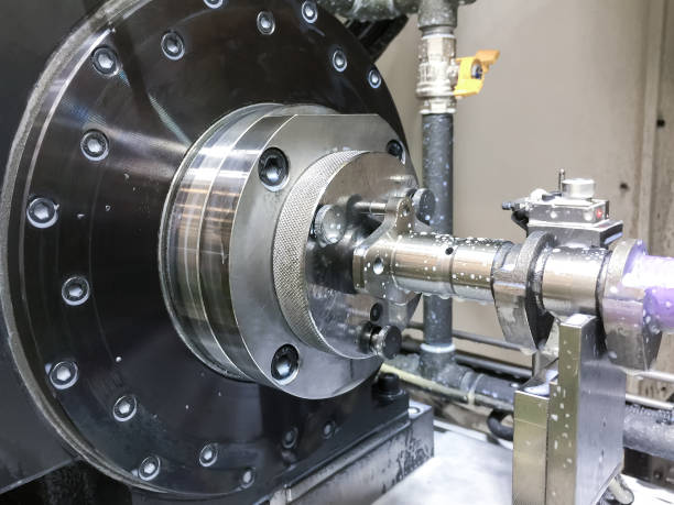 istock High precision CNC machining center working, operator machining automotive part camshaft process 1071081452
