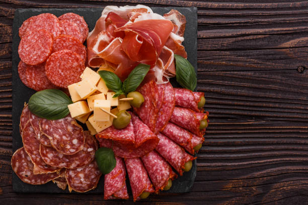 istock Cold smoked meat plate on a rustic wooden background 1071087756