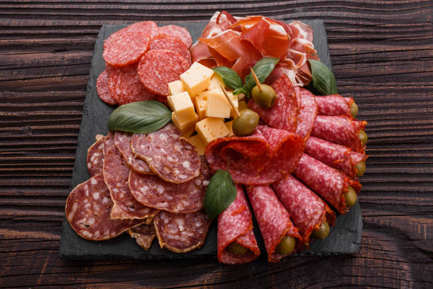 istock Cold smoked meat plate on a rustic wooden background 1071087866