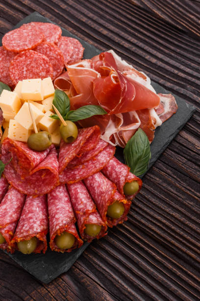 istock Cold smoked meat plate on a rustic wooden background 1071088038
