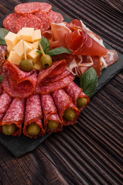 istock Cold smoked meat plate on a rustic wooden background 1071088084