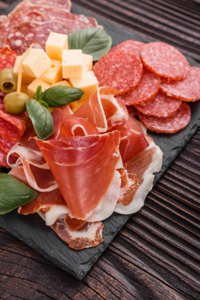 istock Cold smoked meat plate on a rustic wooden background 1071088100