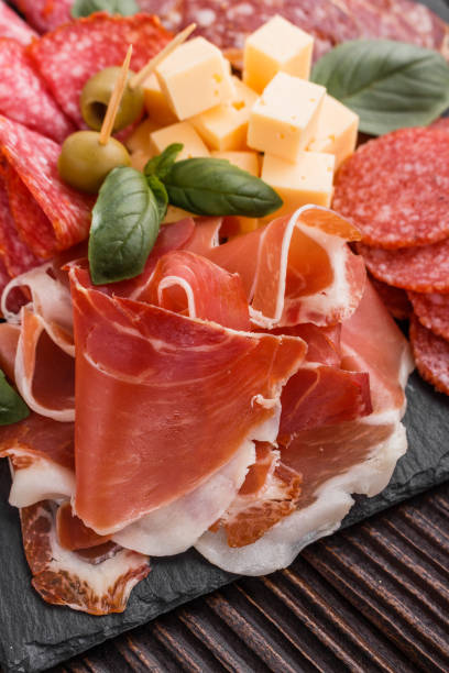 istock Cold smoked meat plate on a rustic wooden background 1071089490
