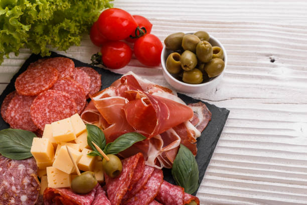 istock Cold smoked meat plate on a rustic wooden background 1071089714