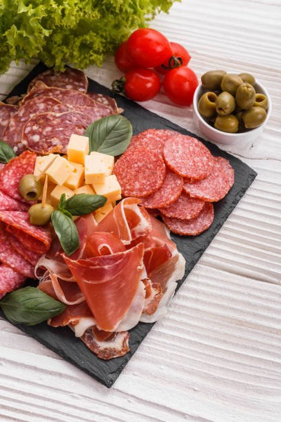 istock Cold smoked meat plate on a rustic wooden background 1071089912