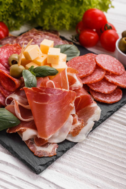 istock Cold smoked meat plate on a rustic wooden background 1071089930