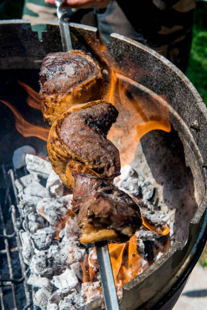 istock Picanha skewer cooks on the coals and flames 1071091212