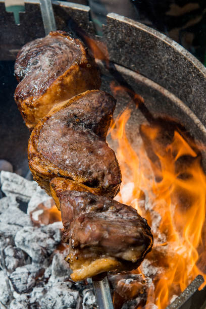 istock Picanha skewer cooks on the coals and flames 1071091448