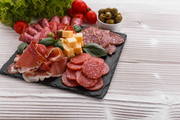 istock Cold smoked meat plate on a rustic wooden background 1071093730