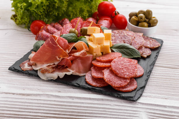 istock Cold smoked meat plate on a rustic wooden background 1071093734