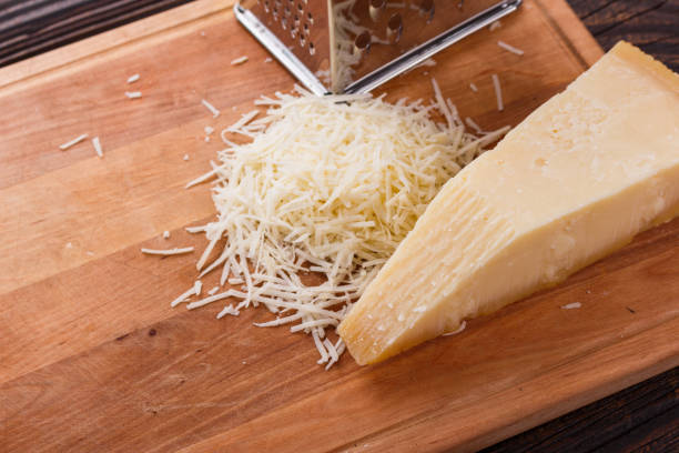 istock fragrant grated Parmesan on a wooden slicing board 1071094298