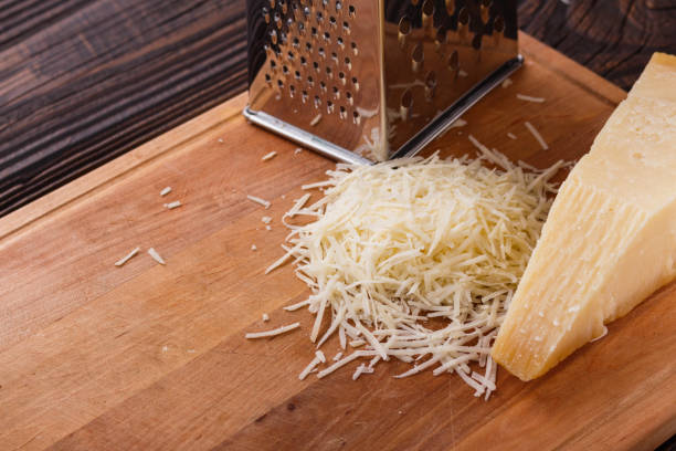 istock fragrant grated Parmesan on a wooden slicing board 1071094372