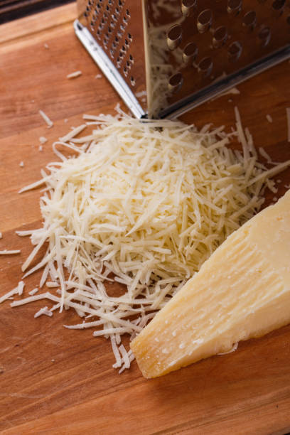 istock fragrant grated Parmesan on a wooden slicing board 1071094414