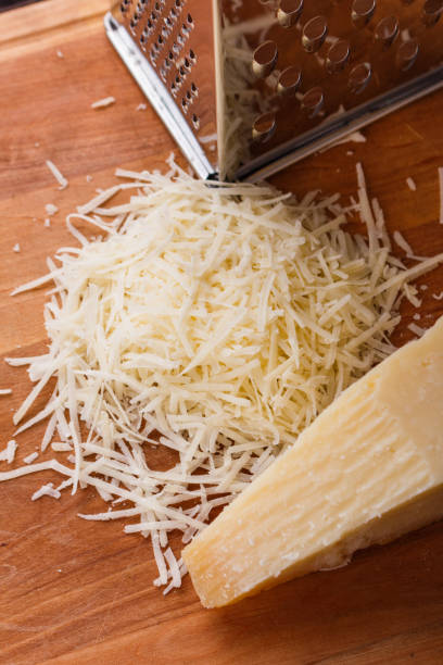 istock fragrant grated Parmesan on a wooden slicing board 1071094452