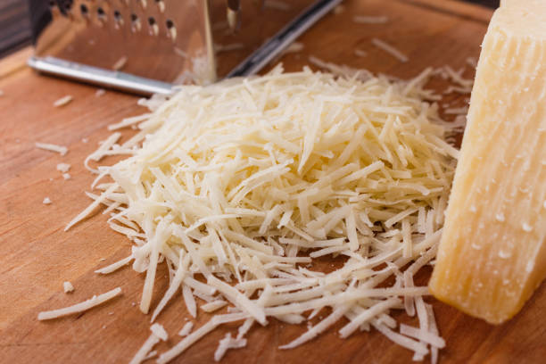 istock fragrant grated Parmesan on a wooden slicing board 1071094524