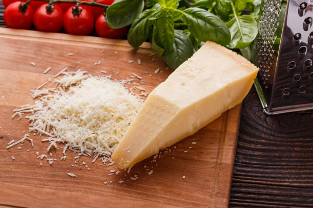istock fragrant grated Parmesan on a wooden slicing board 1071094690