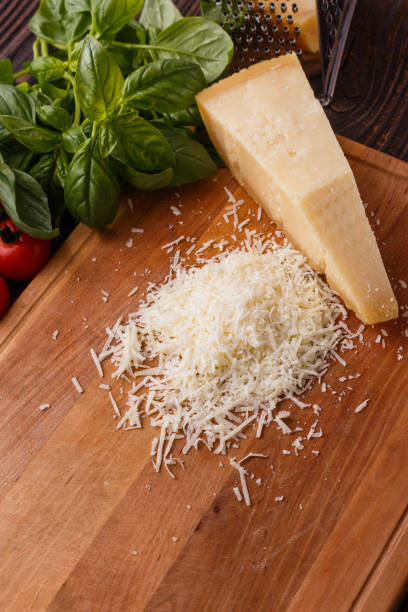 istock fragrant grated Parmesan on a wooden slicing board 1071094804