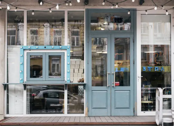 Photo of A cafe facade design with stylish elements and furniture. Lot of wooden elements.