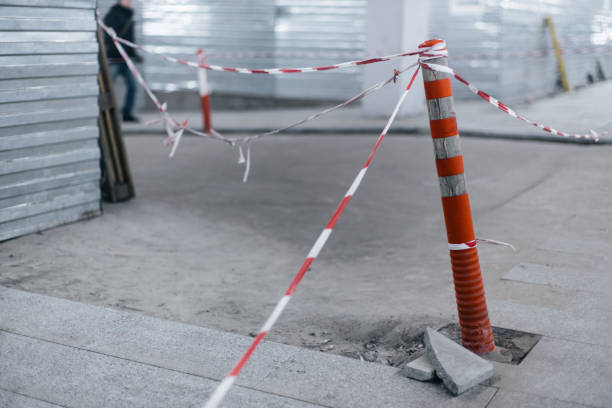 istock Orange fence cone with striped tape at building 1071097266