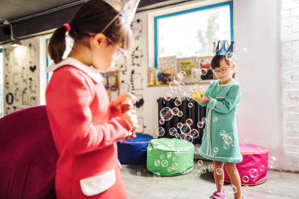 istock Sisters having Down syndrome having funny time in kindergarten 1071097478