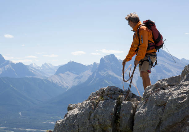 istock Male climber belays using rope in mountains 1071098026