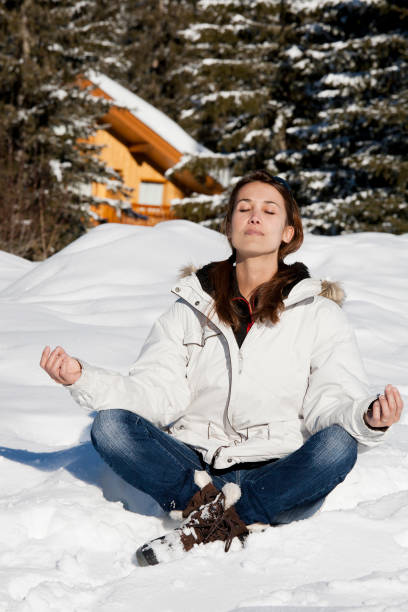 istock woman sitting in the snow relaxing 1071099142