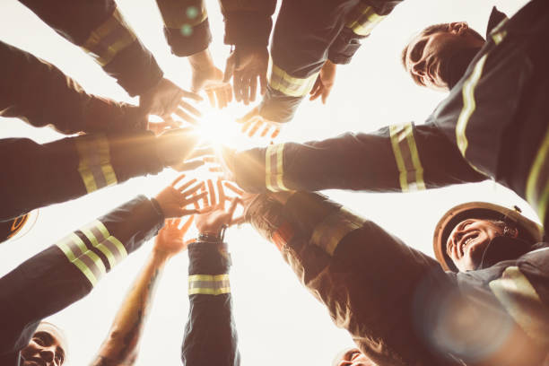 firefighters doing high five - bombeiro imagens e fotografias de stock