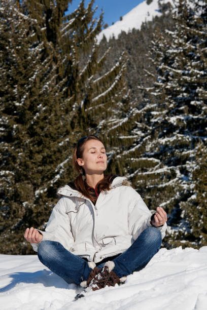 istock woman sitting in the snow relaxing 1071099266