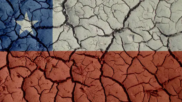 Political Crisis Or Environmental Concept: Mud Cracks With Chile Flag