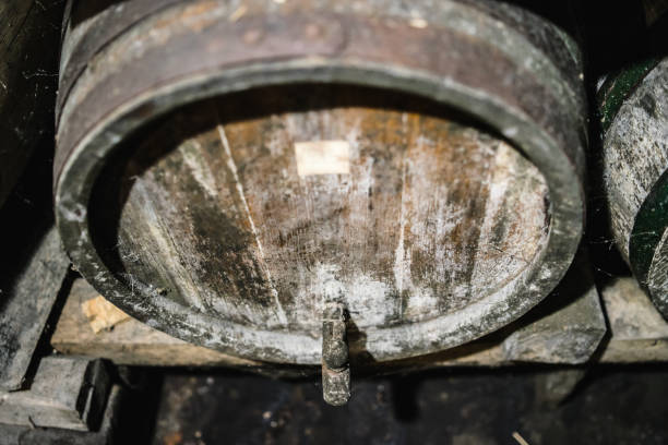Old Cellar With Wine, Raki, Brandy Whiskey, Porto, Wooden Barrels covered with dust. Traditional
