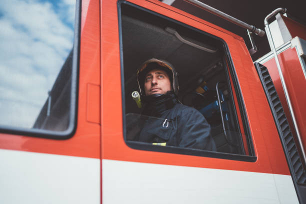 istock Firefighter in the fire truck 1071099678