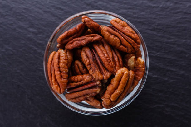 istock delicious pecan nuts on a dark stone background 1071110498
