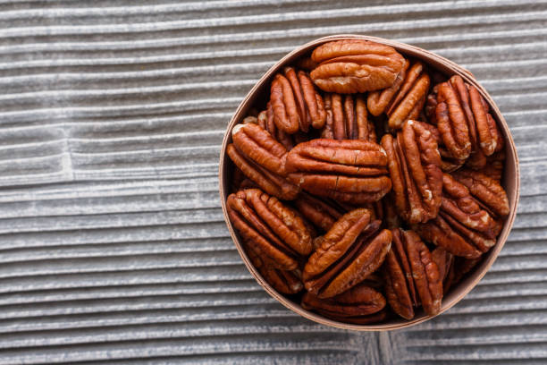 istock delicious pecan nuts on a rustic wooden background 1071112132