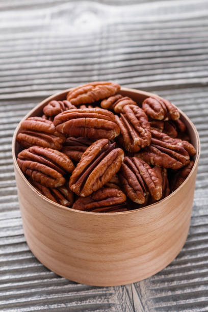 istock delicious pecan nuts on a rustic wooden background 1071112288