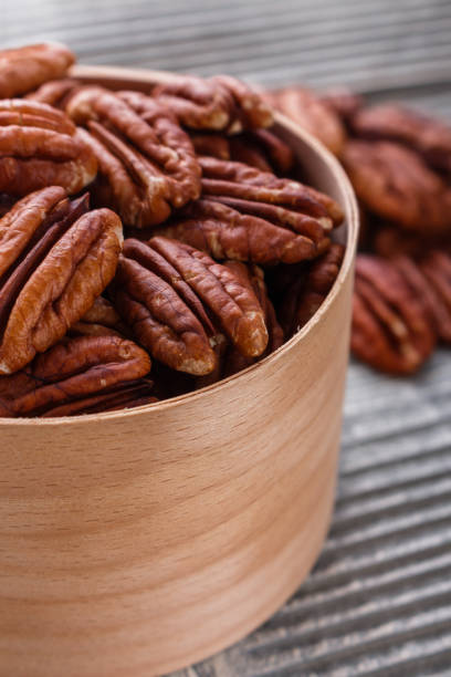 istock delicious pecan nuts on a rustic wooden background 1071112384