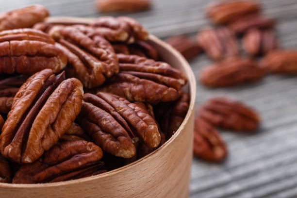 istock delicious pecan nuts on a rustic wooden background 1071112430
