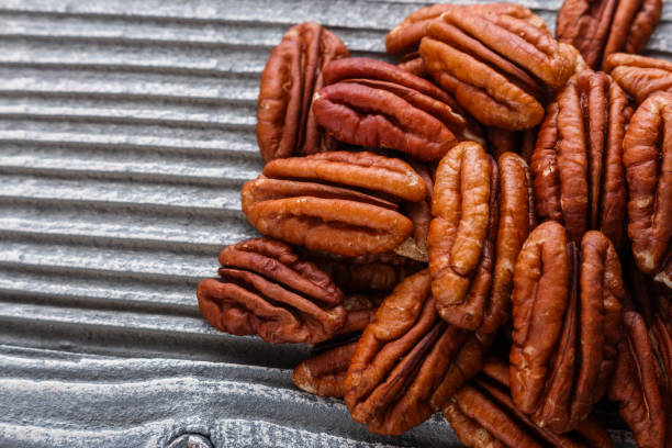 istock delicious pecan nuts on a rustic wooden background 1071112804
