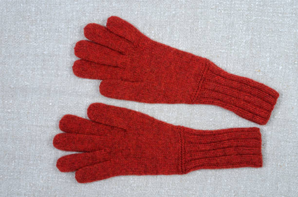 istock Red gloves on fabric background. 1071113196