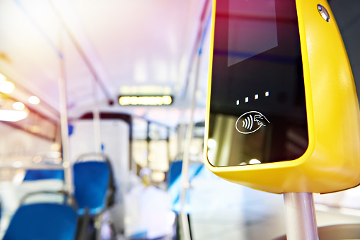 Modern touch payment terminal in bus