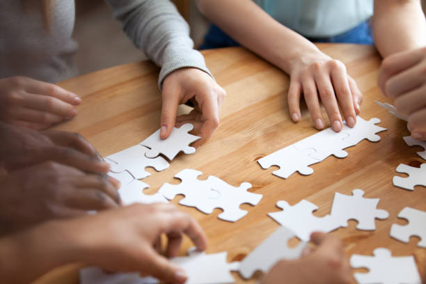 istock Hands of multiracial people assembling puzzle close up 1071117700