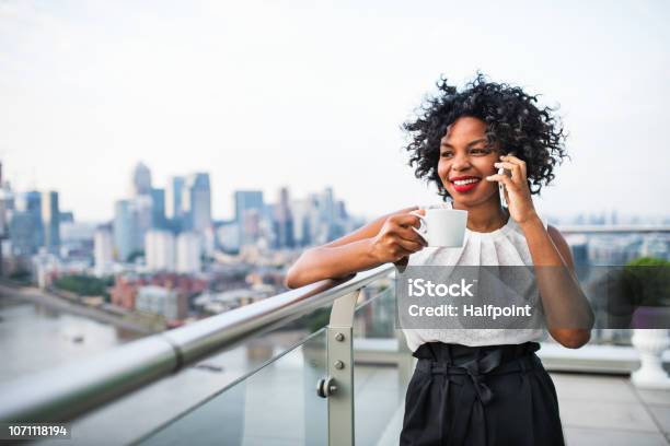 A Businesswoman Standing Against London View Panorama Making A Phone Call Stock Photo - Download Image Now