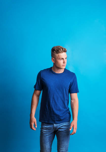 Portrait of a serious thoughtful young man in a studio standing in a studio.