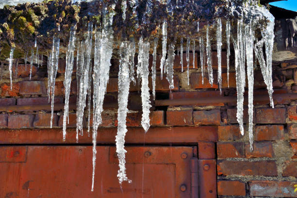 istock Icicles hanging on roof dripping close up 1071121926