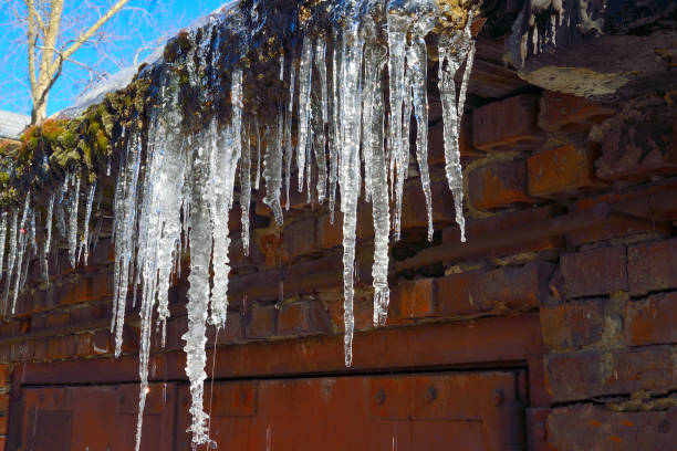 istock Icicles hanging on roof dripping close up 1071121932