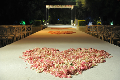 Beautiful photo of the Jewish Hupa , wedding putdoor .Beautifully registered Huppa with a petals of roses are laid out a heart