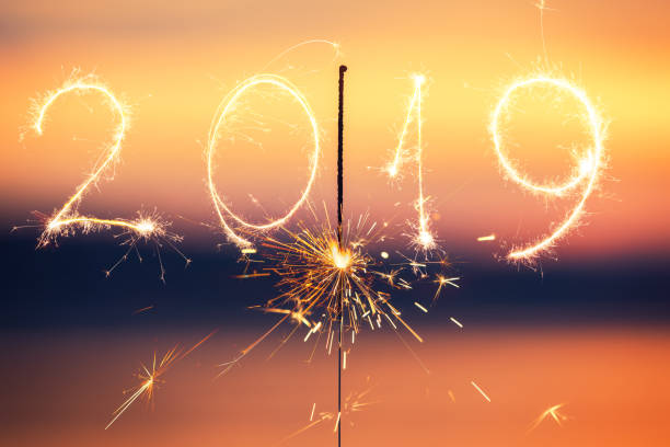 istock 2019 written with Sparkle firework on sunset background, happy new year 1071123766